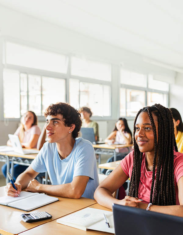 Diverse young high school students listening to teacher in classroom. Education lifestyle and lecture concept