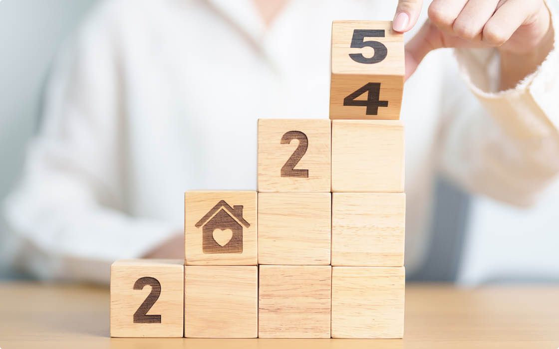 2024 end year to Happy New Year 2025 with Home and Heart block. Property investment, House Mortgage, Real Estate tax, homeless, donation, Financial and happy family concepts