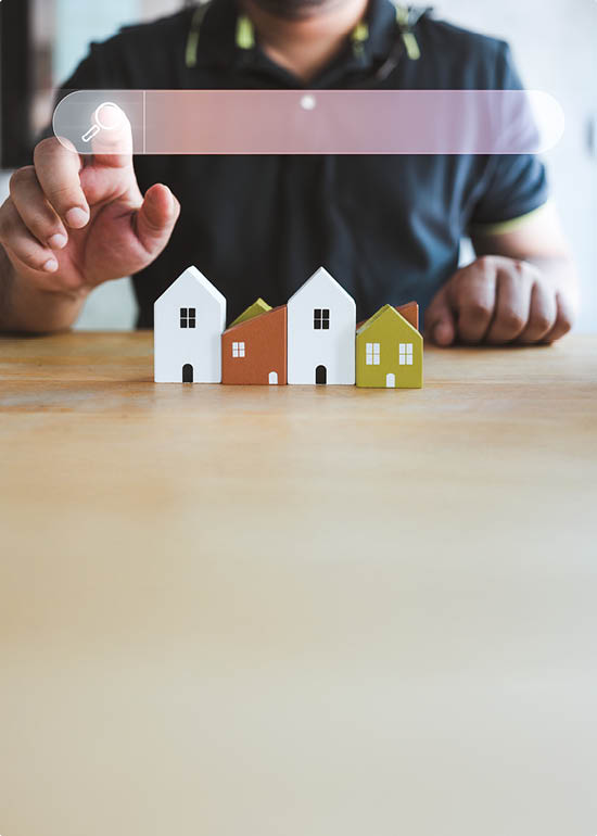 Hand of man touching magnifying glass icon search for find information data about home on top of a model wood house. Search advertising for rent or buy a home. Search Engine Optimization